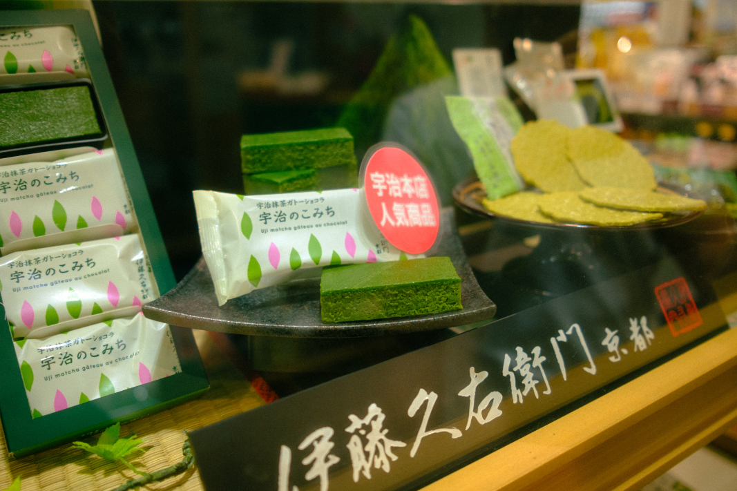 Display of matcha sweets and green tea desserts in a Japanese shop window