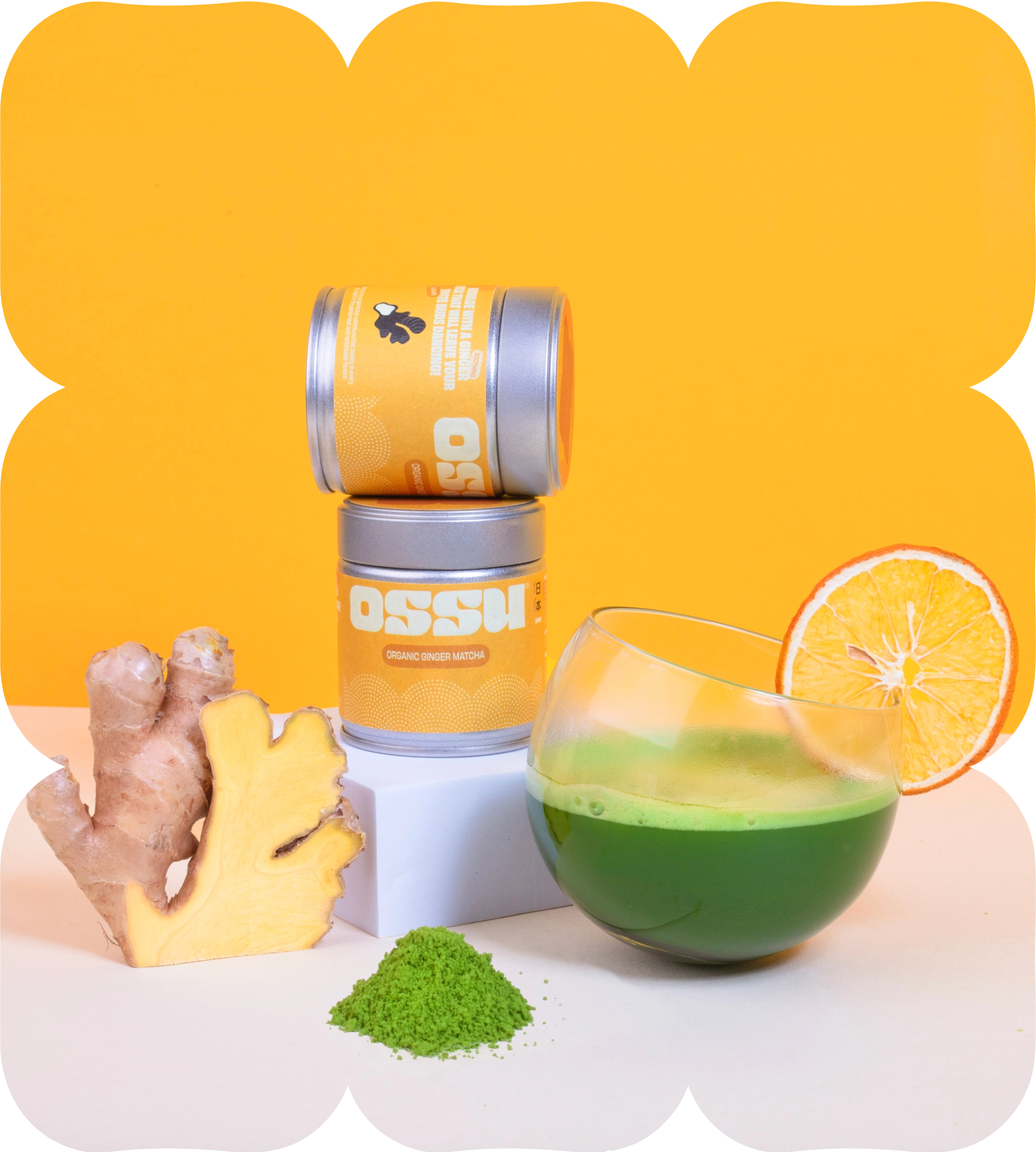 OSSU organic ginger matcha tins with fresh ginger root and a glass of prepared matcha tea