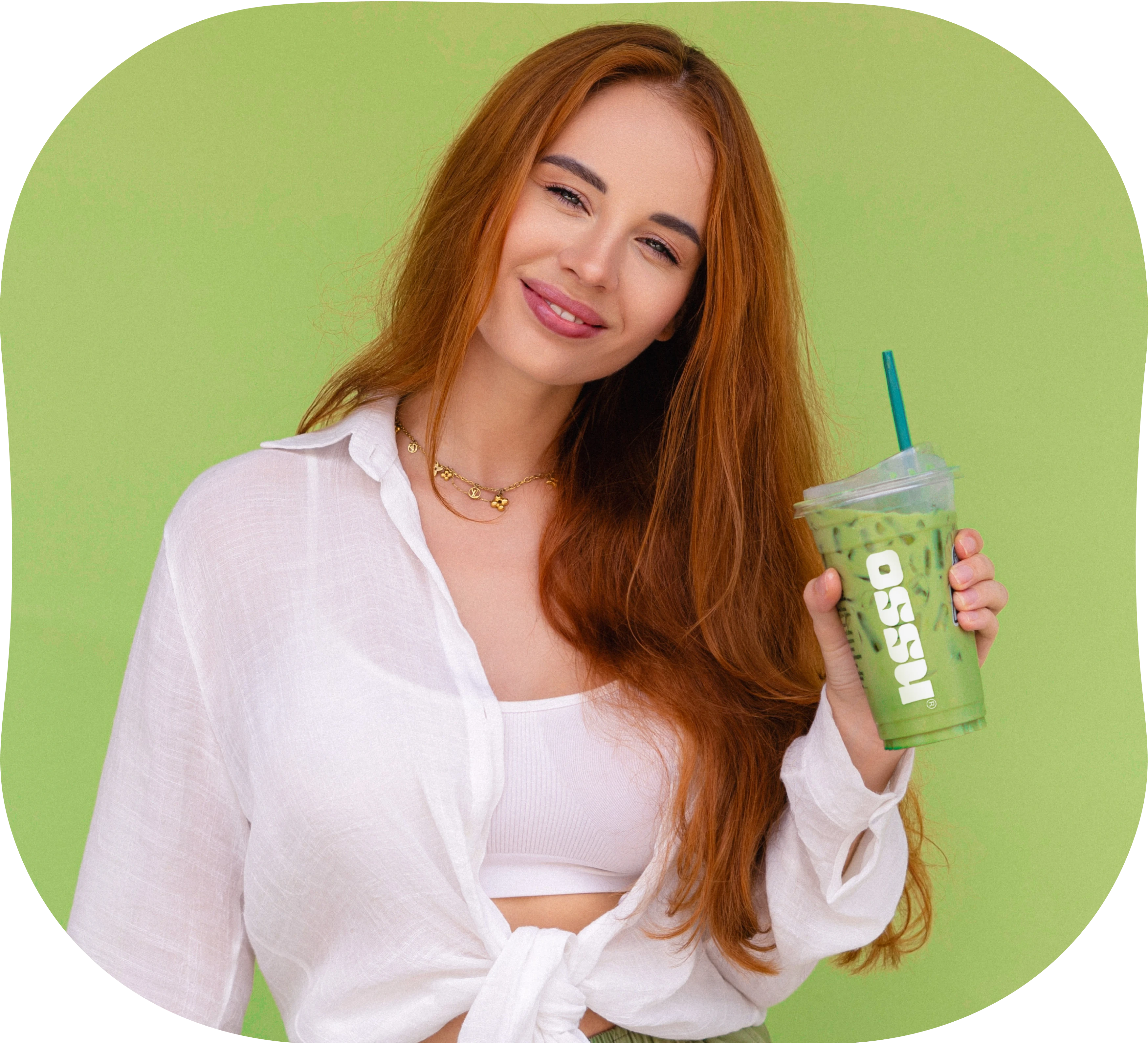 Woman holding an iced green matcha latte in an OSSU branded takeaway cup