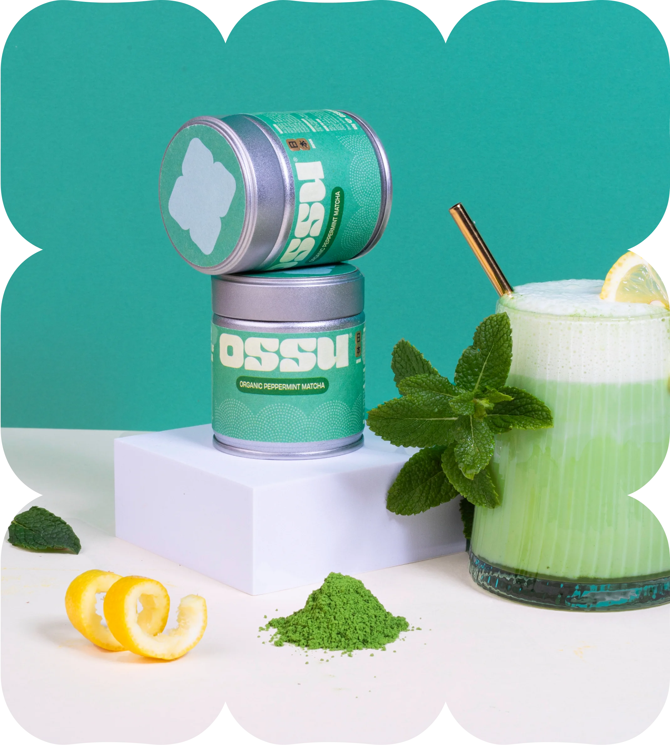Two tins of OSSU organic peppermint matcha with mint leaves and a glass of iced matcha drink